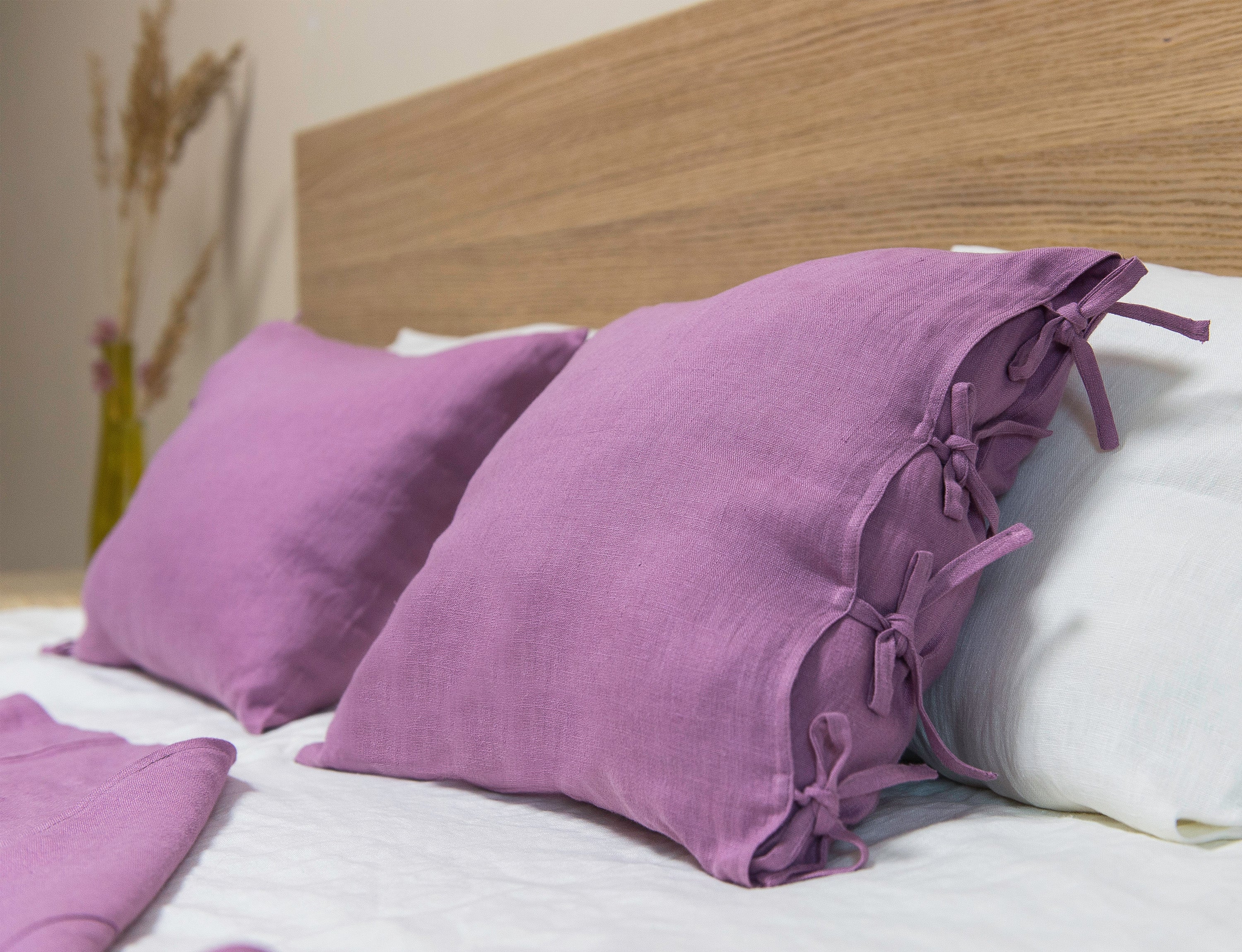 Deep Rose linen pillowcase with elegant tie closure, showcasing soft texture and rich color.