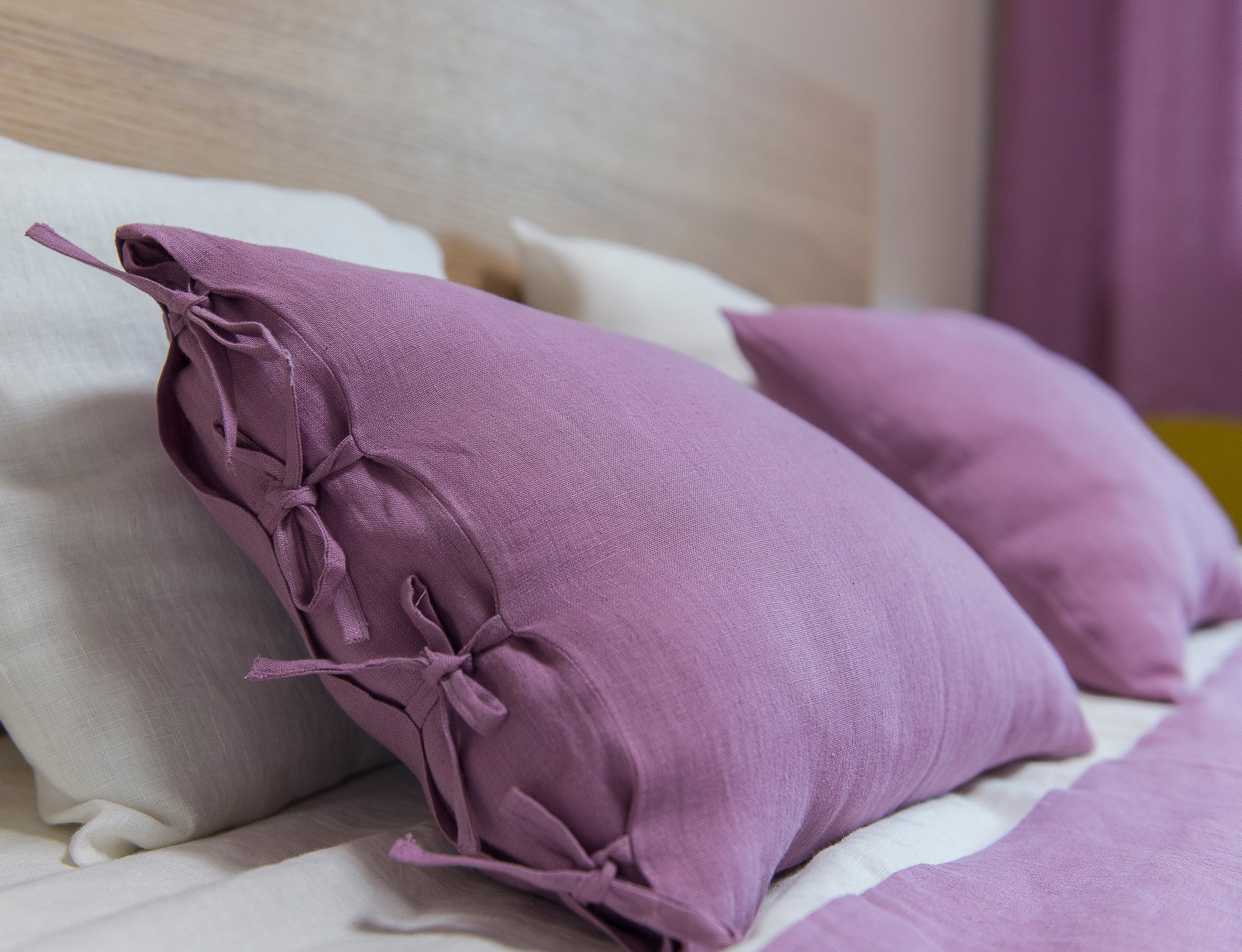 Deep Rose linen pillowcase with elegant tie closure, showcasing soft texture and rich color.