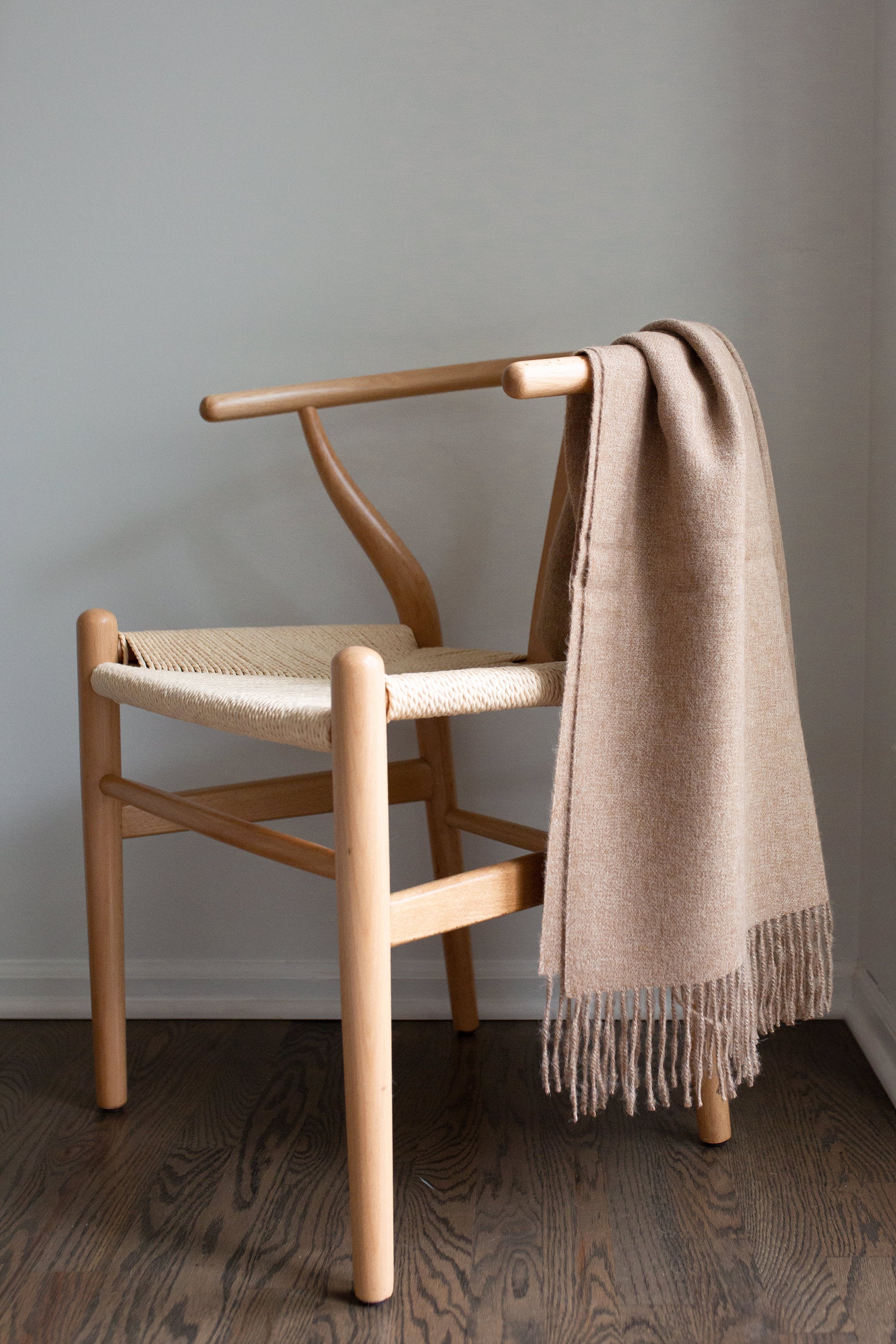 Encanto Alpaca Throw in Sandy Beige, showcasing its soft texture and elegant design, perfect for home decor.