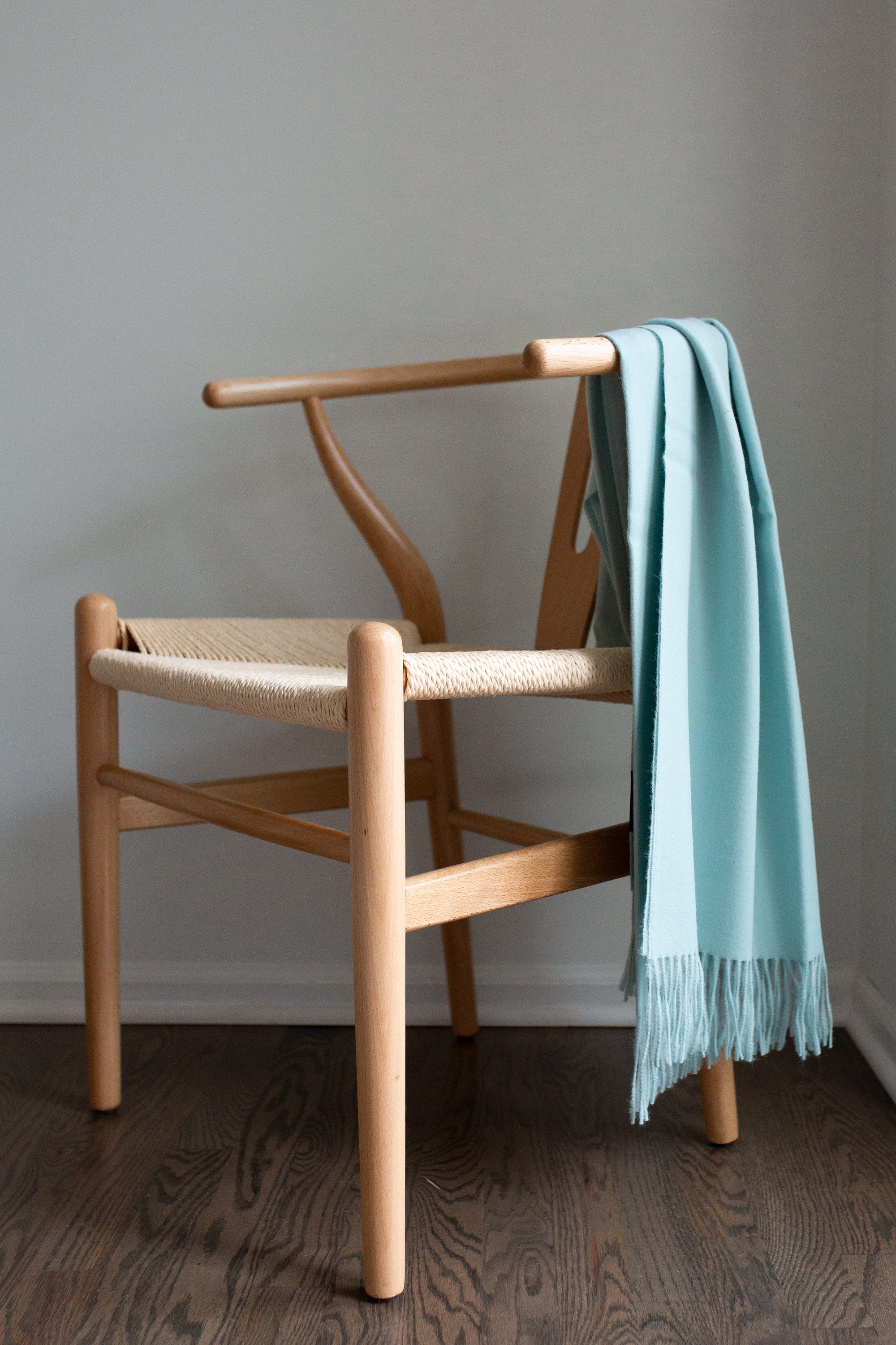 Esencia Alpaca Throw in Sky Blue, showcasing its soft texture and elegant design, perfect for home decor.