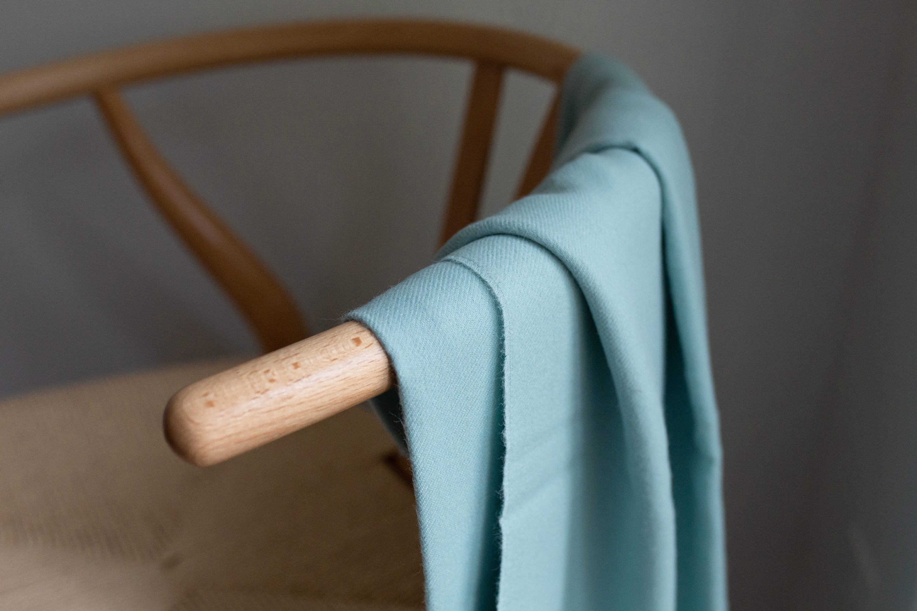 Esencia Alpaca Throw in Sky Blue, showcasing its soft texture and elegant design, perfect for home decor.