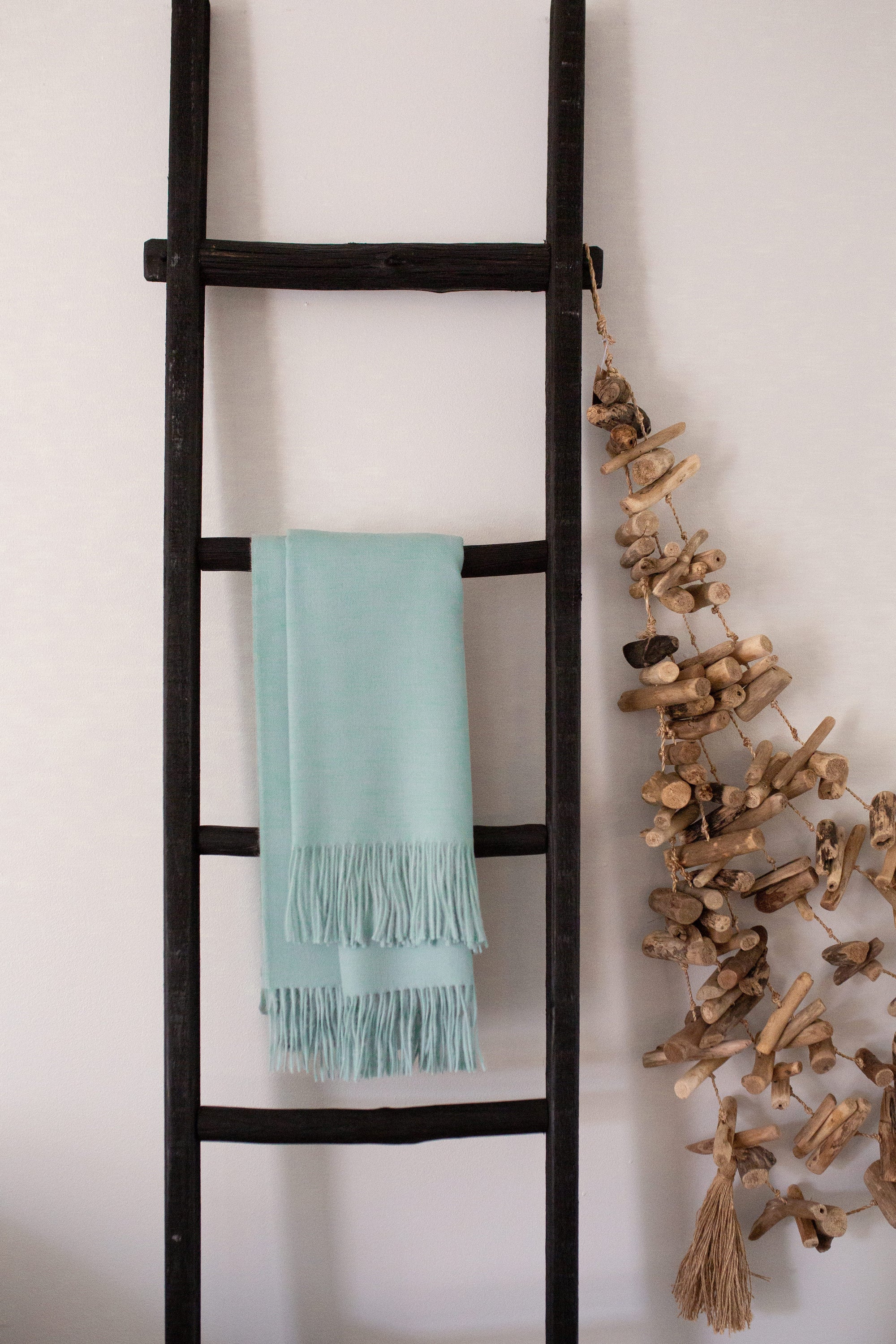Esencia Alpaca Throw in Sky Blue, showcasing its soft texture and elegant design, perfect for home decor.