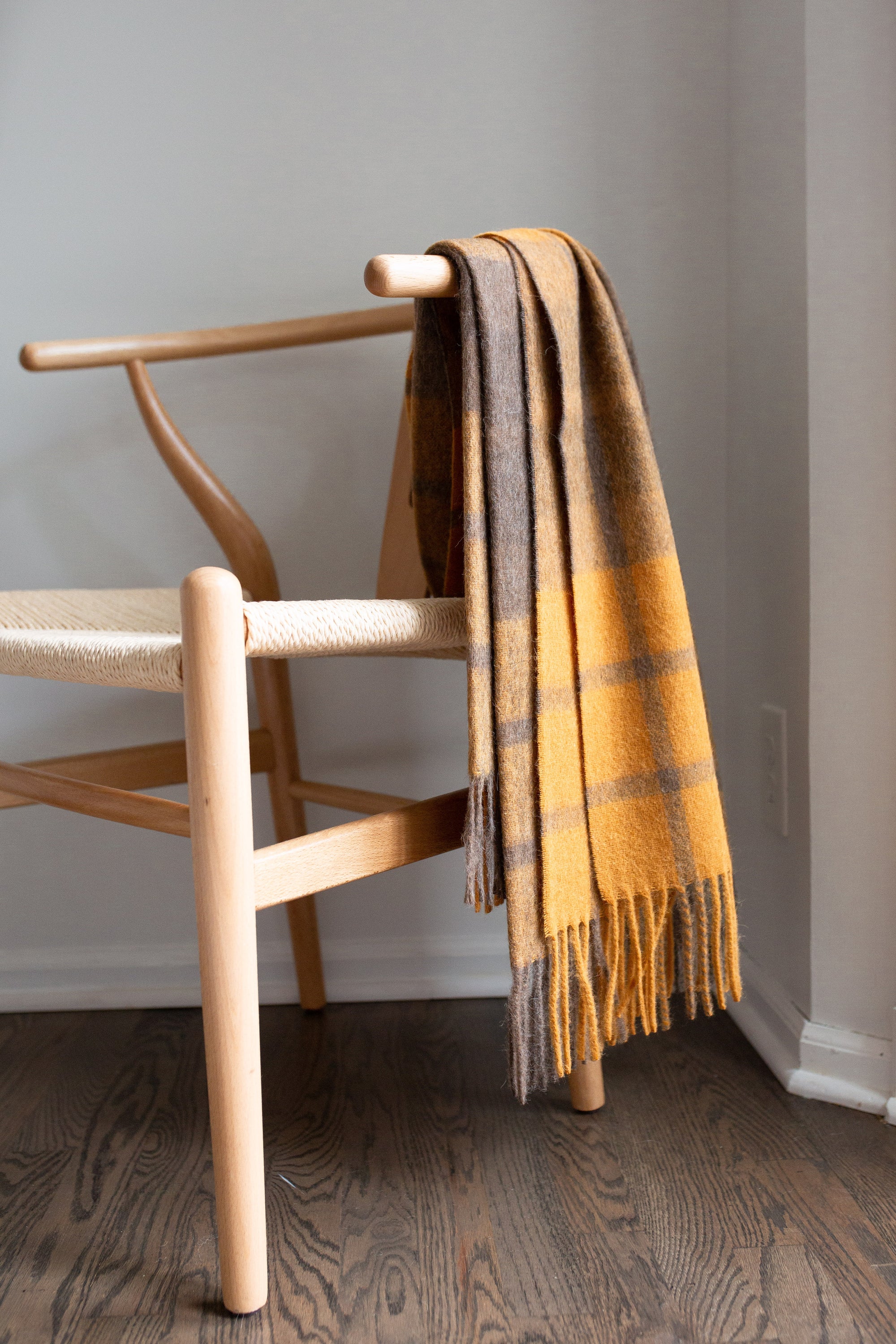 Estancia Alpaca Blend Throw in Grey and Mustard Yellow, showcasing its soft texture and elegant design.