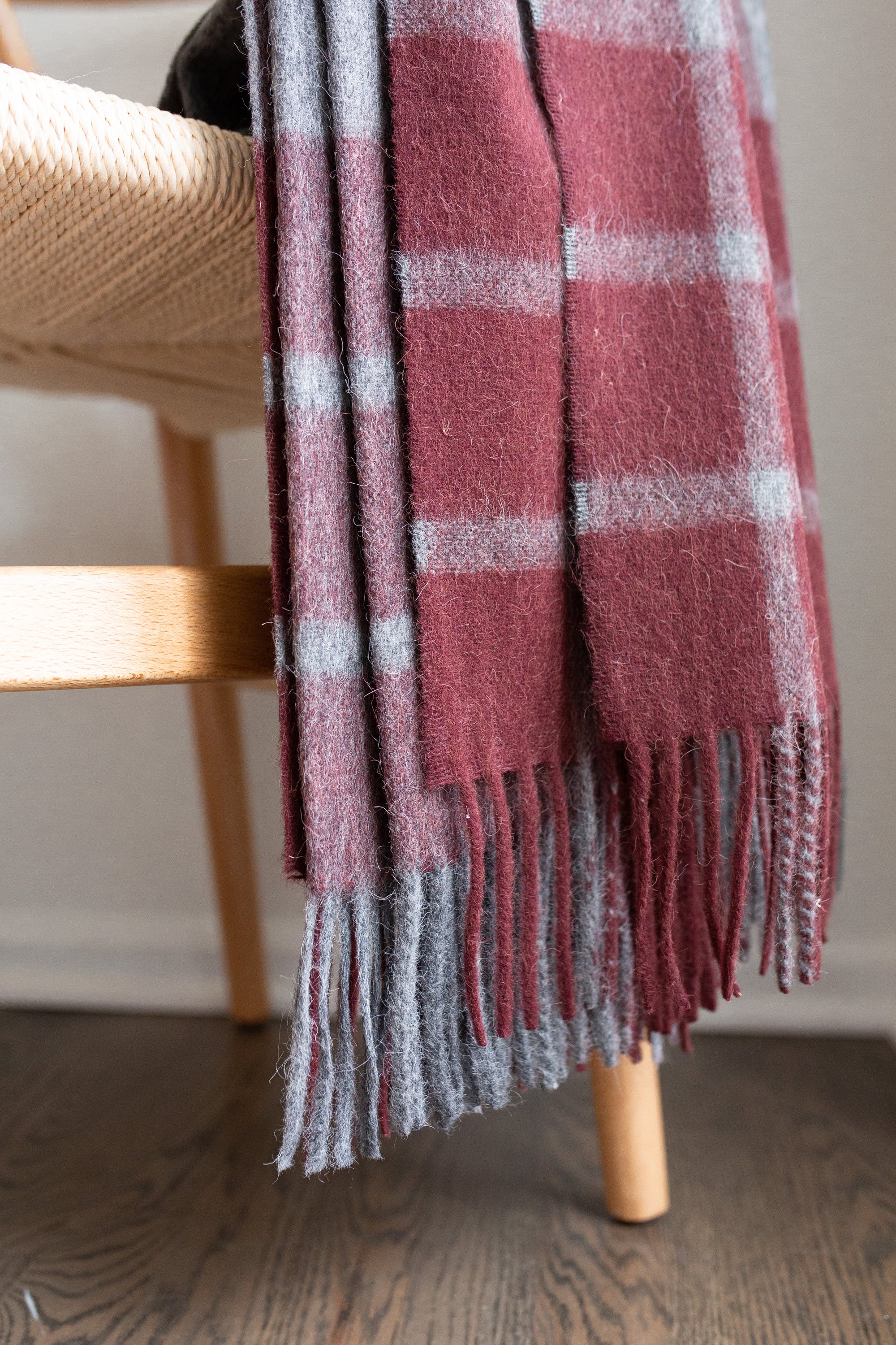 Estancia Alpaca Blend Throw in Grey and Wine, showcasing its soft texture and elegant design, perfect for home decor.