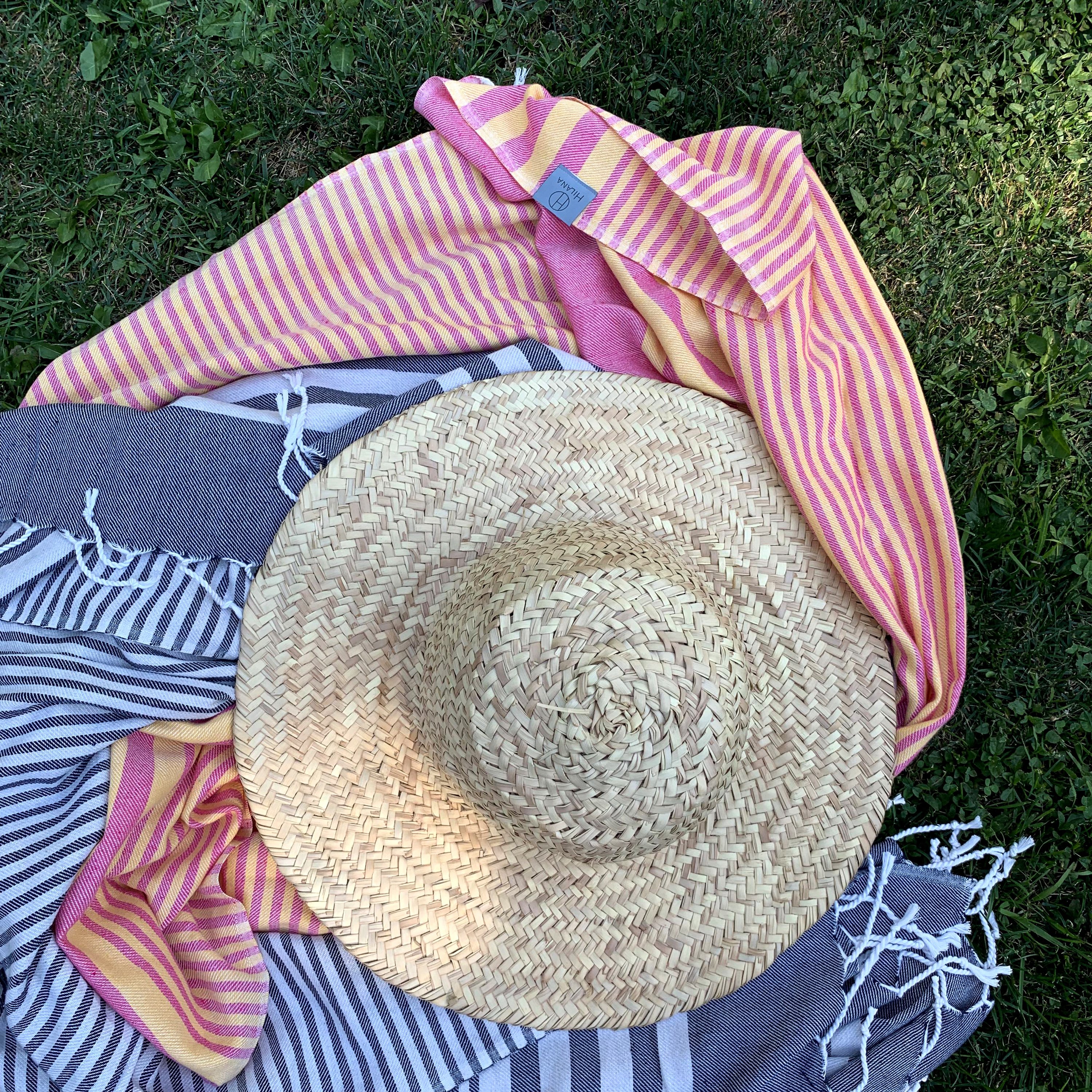 Fethiye Striped Blanket Throw in Blue with navy stripes, showcasing its soft texture and compact design, perfect for indoor and outdoor use.
