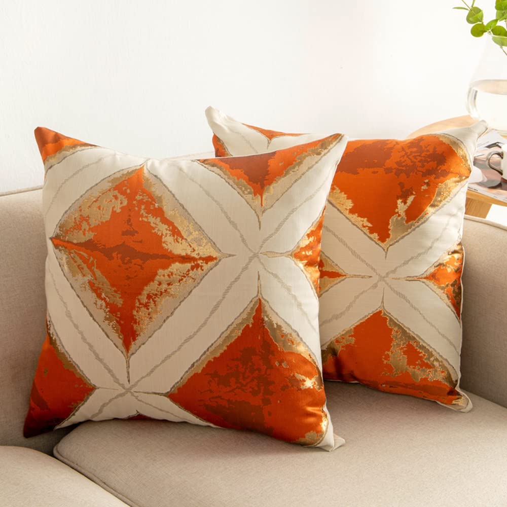 Geometric pattern cushion cover in orange and green, 45cm x 45cm, showcasing modern design and vibrant colors.