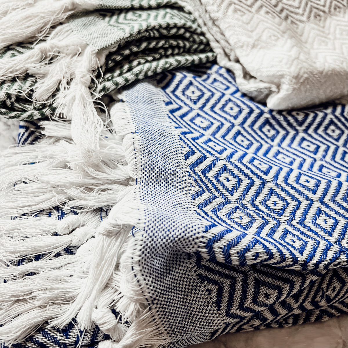 Haley Diamond Towel in blue with decorative tassels, showcasing its oversized design and soft texture.