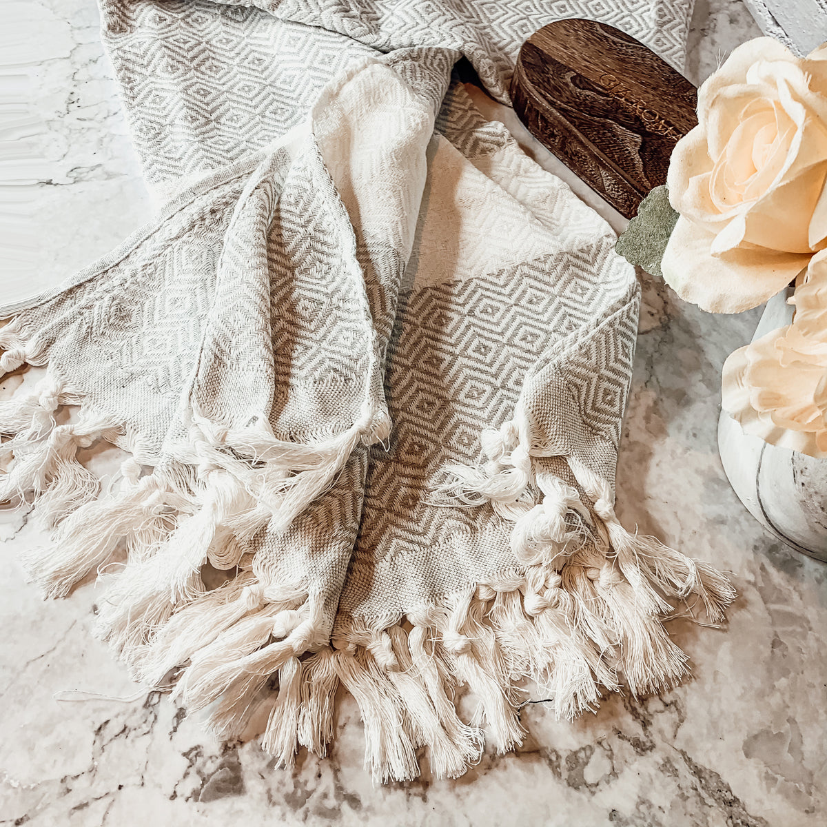 Haley Diamond Towel in blue with decorative tassels, showcasing its oversized design and soft texture.