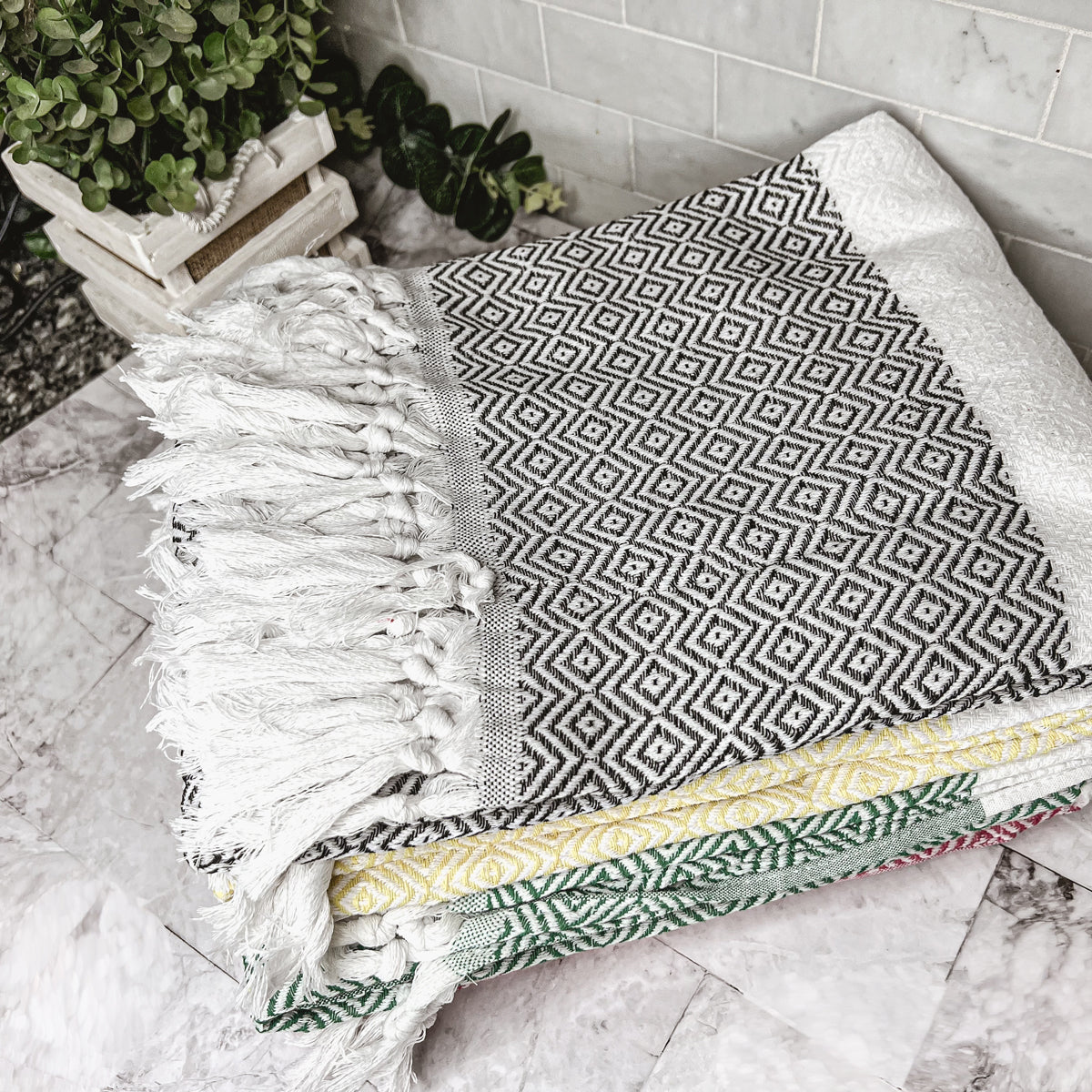 Haley Diamond Towel in blue with decorative tassels, showcasing its oversized design and soft texture.