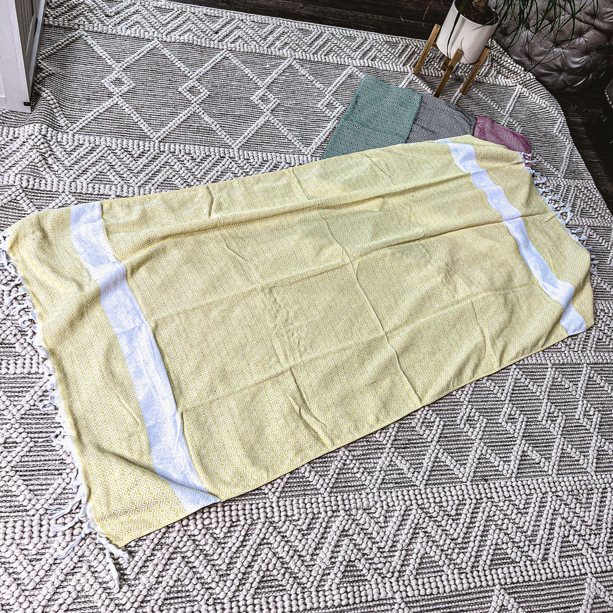 Haley Diamond Towel in blue with decorative tassels, showcasing its oversized design and soft texture.