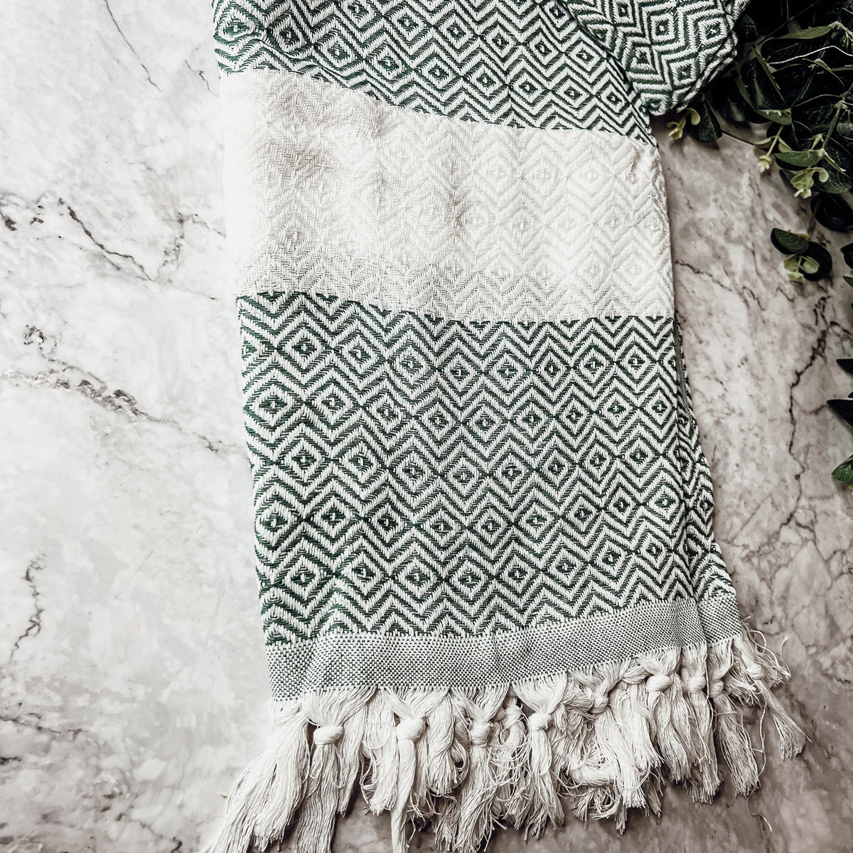 Haley Diamond Towel in blue with decorative tassels, showcasing its oversized design and soft texture.