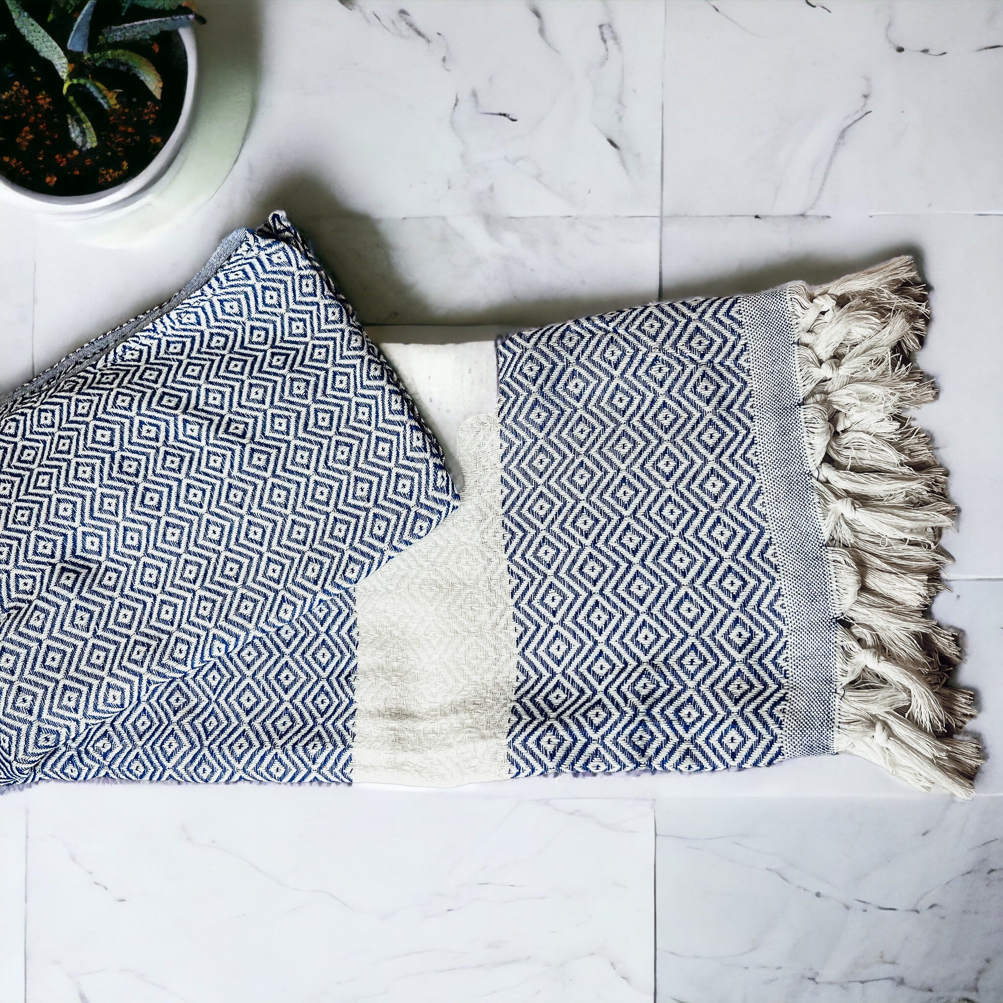 Haley Diamond Towel in blue with decorative tassels, showcasing its oversized design and soft texture.