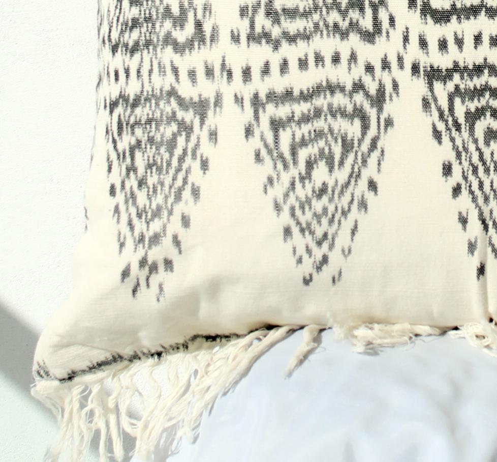 Java Bliss Ikat Pillow featuring handwoven ivory fabric with fringes, perfect for home decor.