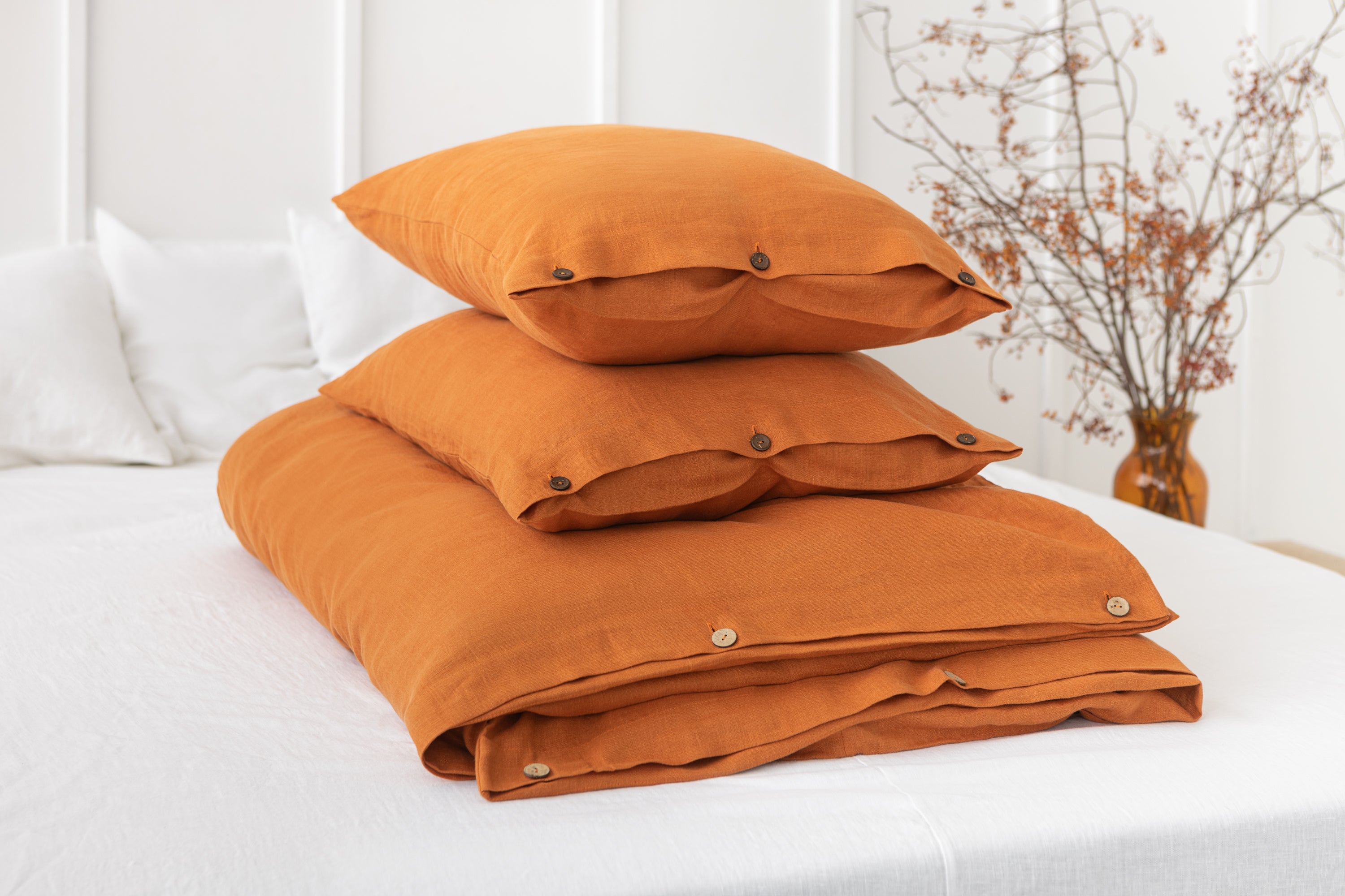 Light Chestnut linen bedding set featuring coconut buttons, elegantly arranged on a bed, showcasing its soft texture and natural color.