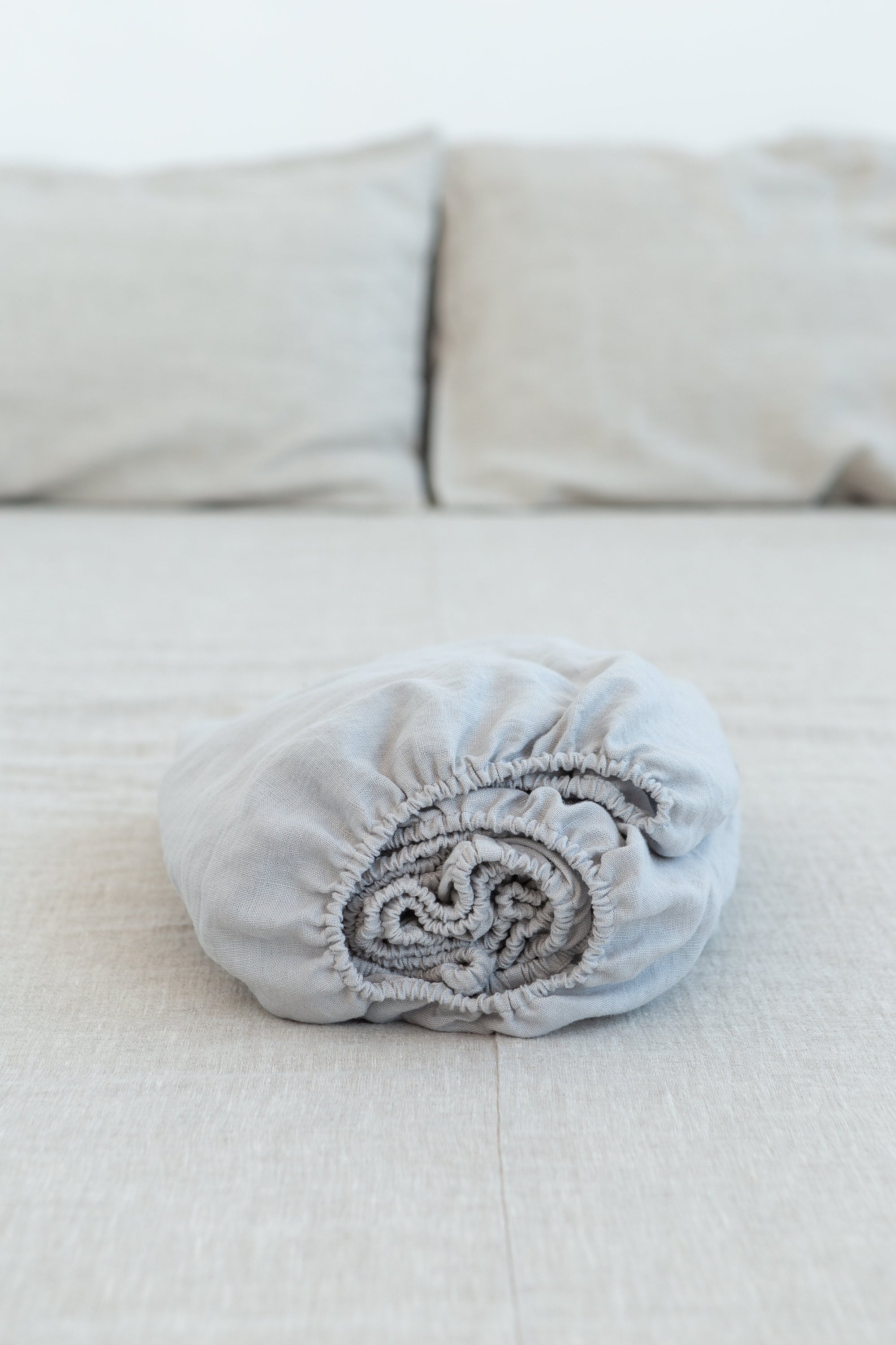 Natural Light linen fitted bed sheet showcasing its soft texture and elegant design, perfect for enhancing bedroom decor.