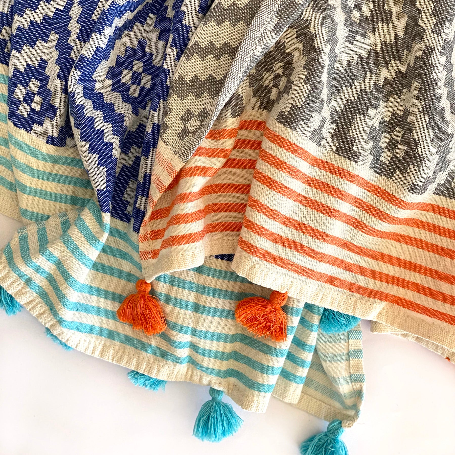 Merida Turkish Towel in blue with hand-knotted tassels, showcasing its unique design and eco-friendly materials.
