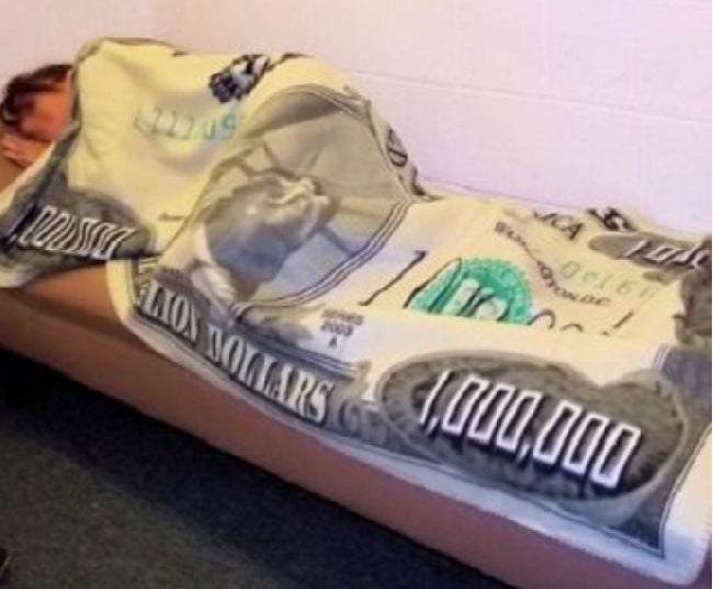 A plush Million-dollar Novelty Blanket made of high-quality flannel, featuring realistic prints and a cozy design, perfect for lounging or travel.