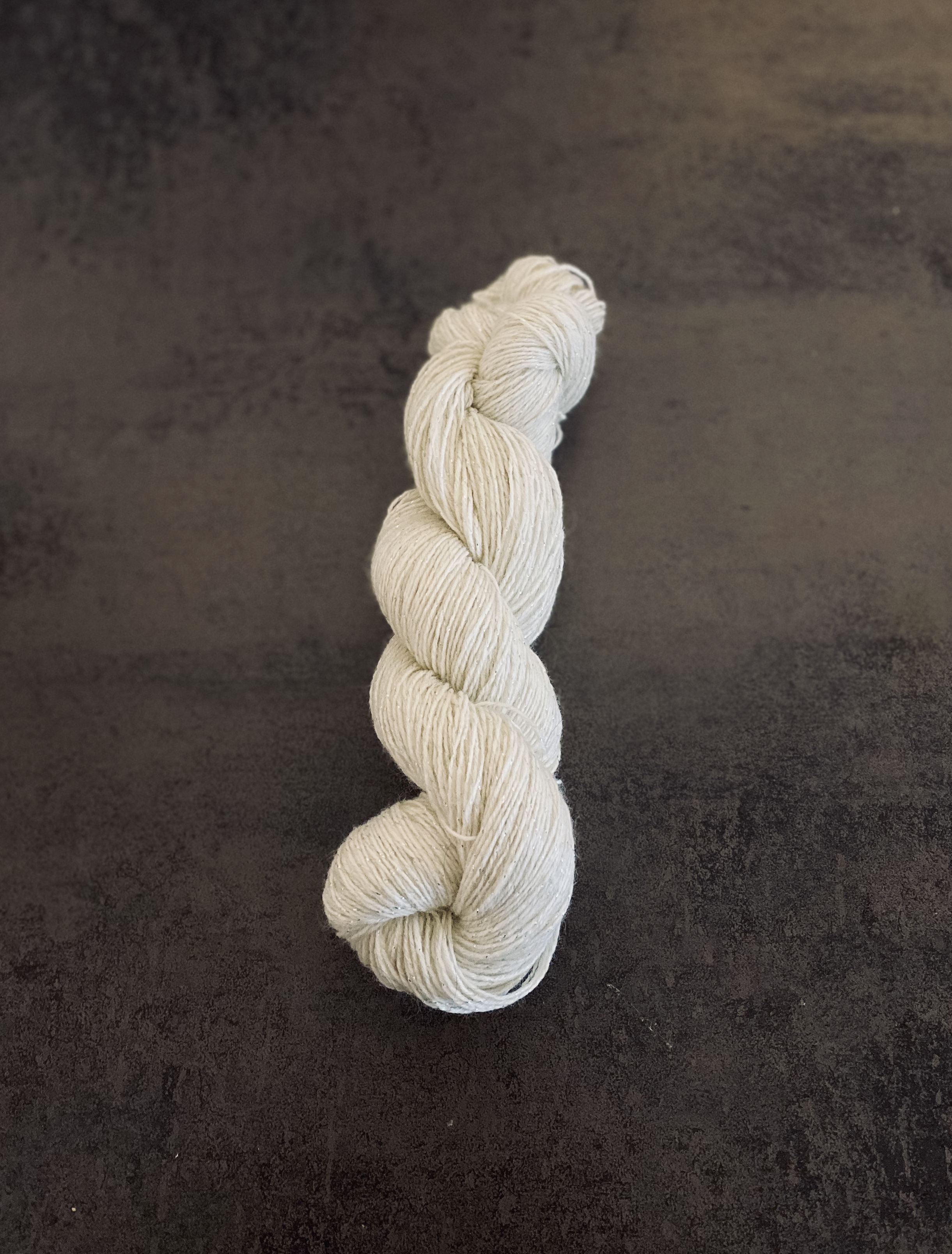 Twisted skein of white yarn.