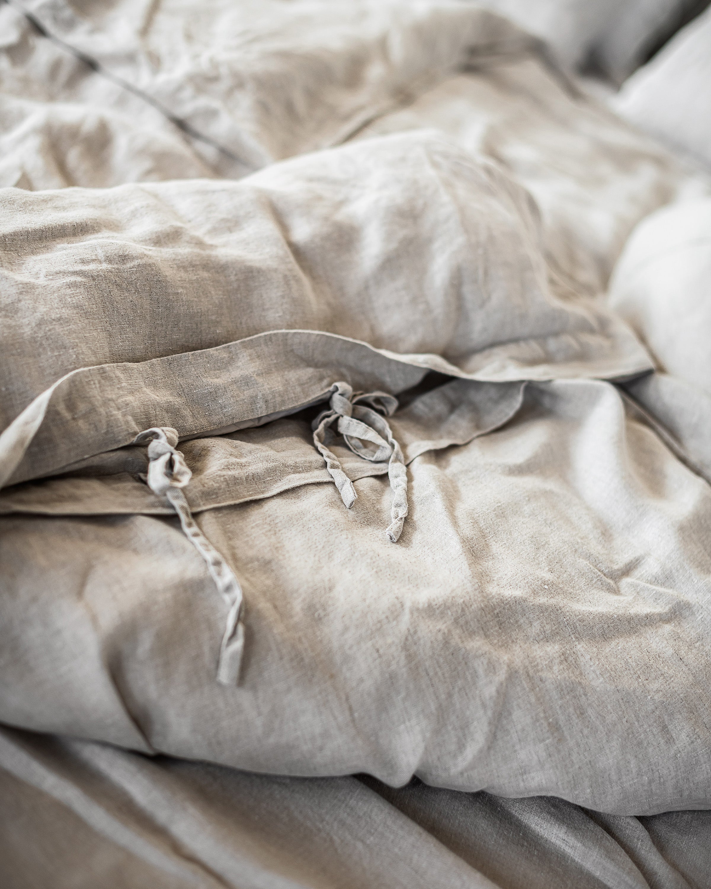 Natural Light linen bedding set featuring a duvet cover with ties, bedsheet, and pillowcases in a soft, elegant design.