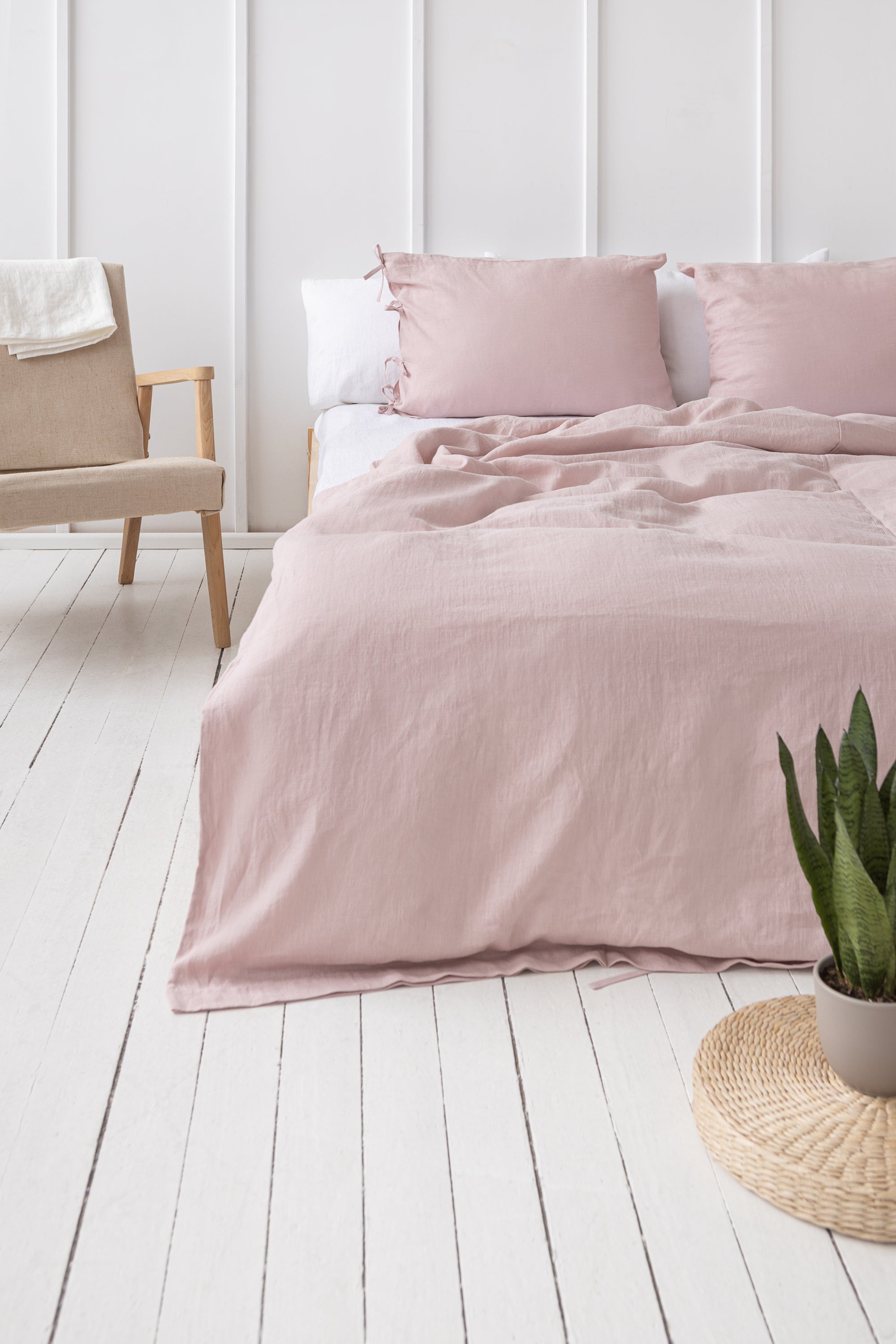Elegant pale pink linen pillowcase with ties, showcasing soft texture and stylish design, perfect for enhancing bedroom decor.