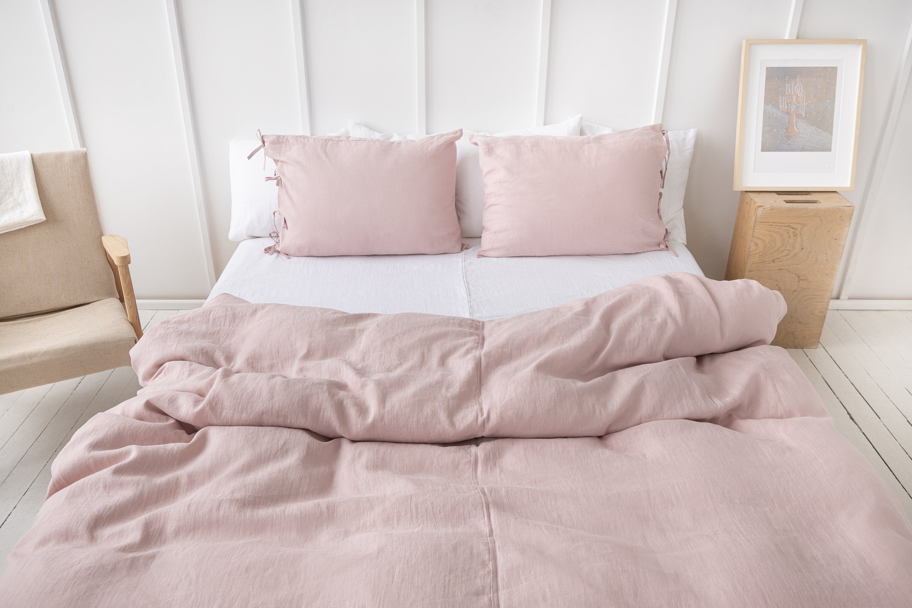 Elegant pale pink linen pillowcase with ties, showcasing soft texture and stylish design, perfect for enhancing bedroom decor.