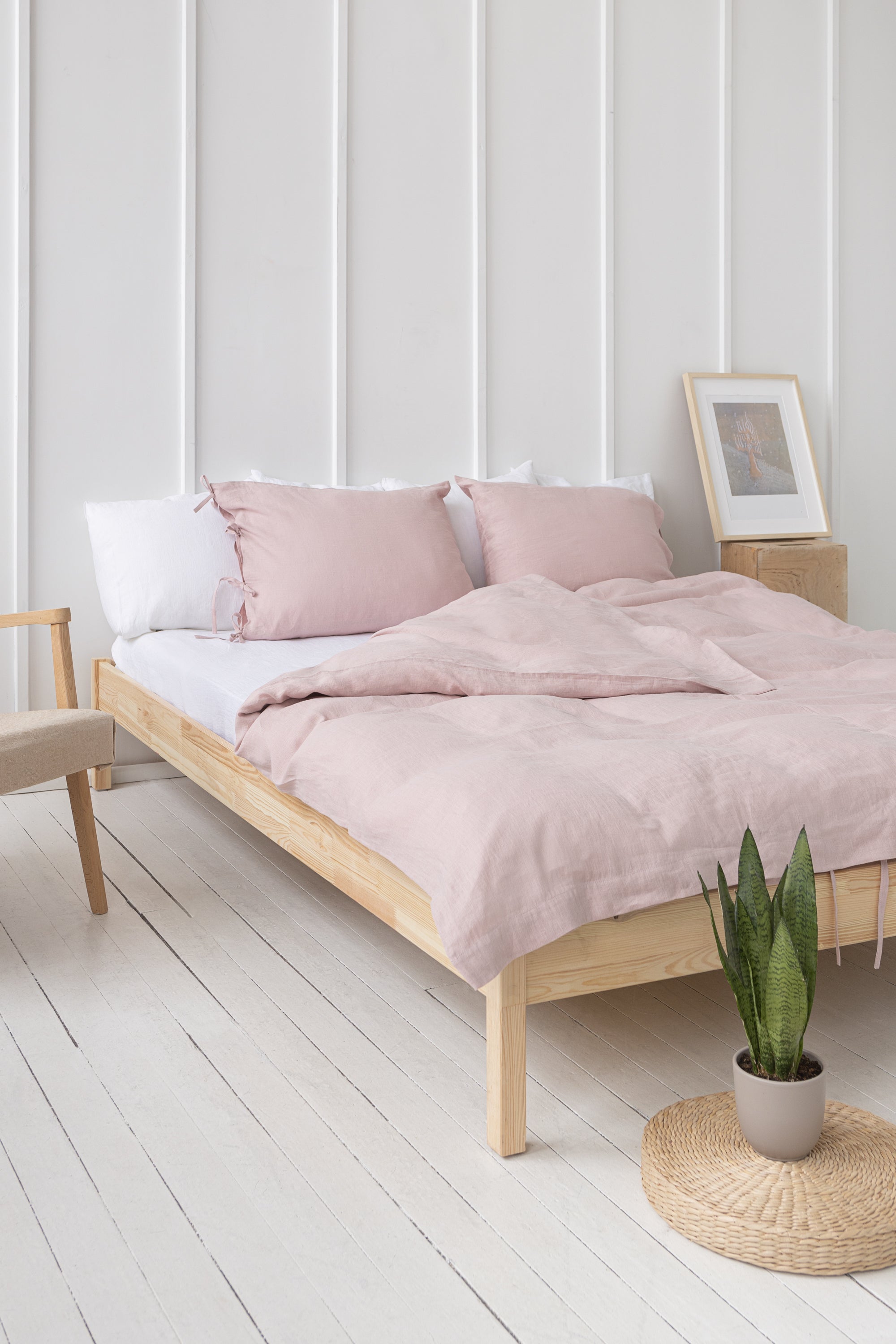 Elegant pale pink linen pillowcase with ties, showcasing soft texture and stylish design, perfect for enhancing bedroom decor.