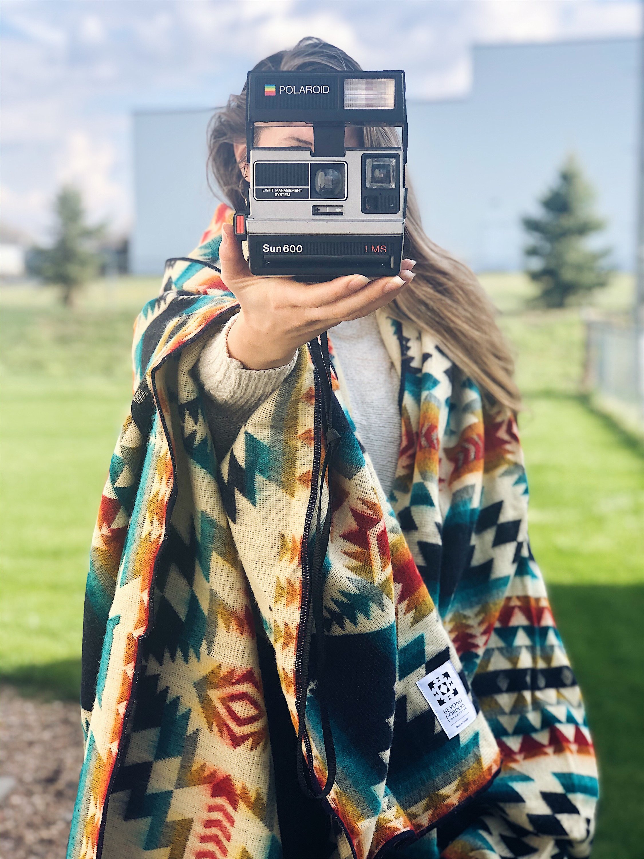 Secoya Blanket - Northern Lights featuring vibrant colors and intricate patterns, handcrafted by Ecuadorian artisans, perfect for cozying up or outdoor use.