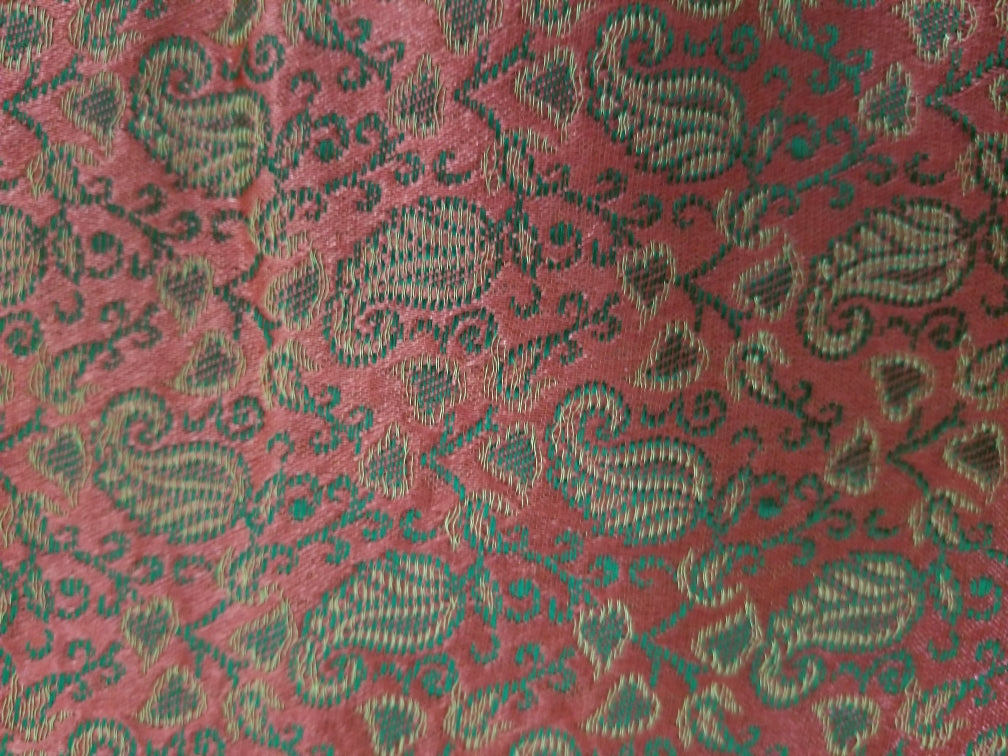 Silk Neck Pillow with paisley design, filled with organic buckwheat hulls, providing neck support for yoga and relaxation.