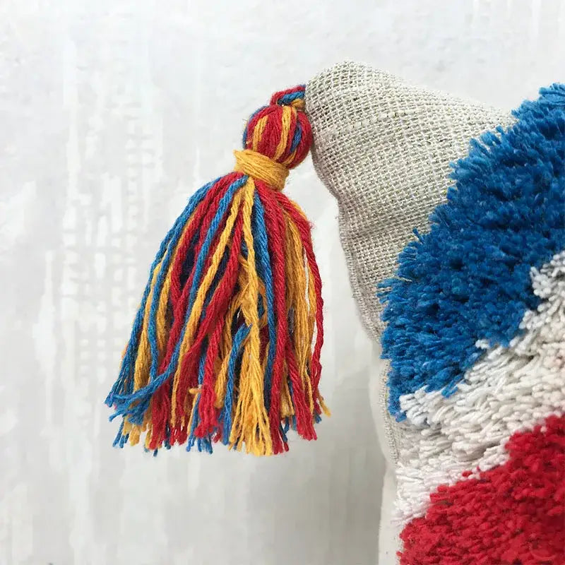 Handmade tassel tufted knitted cushion cover in geometric art design, featuring soft cotton and linen material with a zipper closure.