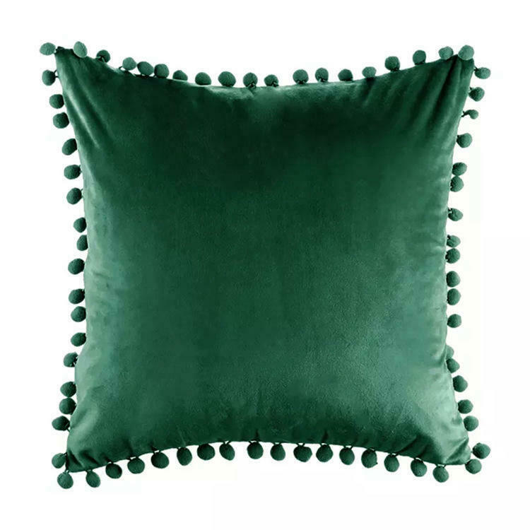Tassel velvet cushion covers with pom poms in a stylish arrangement, showcasing their soft texture and vibrant color.