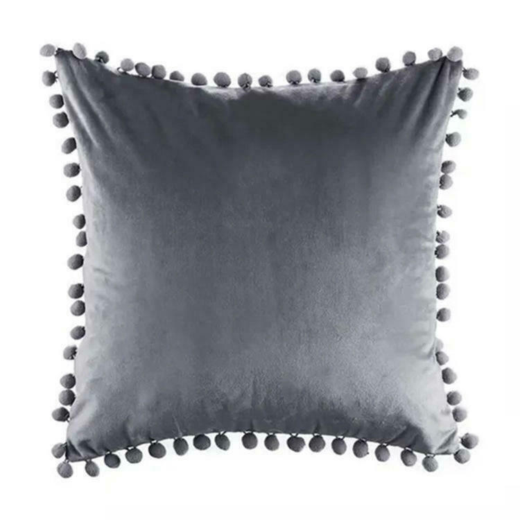 Tassel velvet cushion covers with pom poms in a stylish arrangement, showcasing their soft texture and vibrant color.
