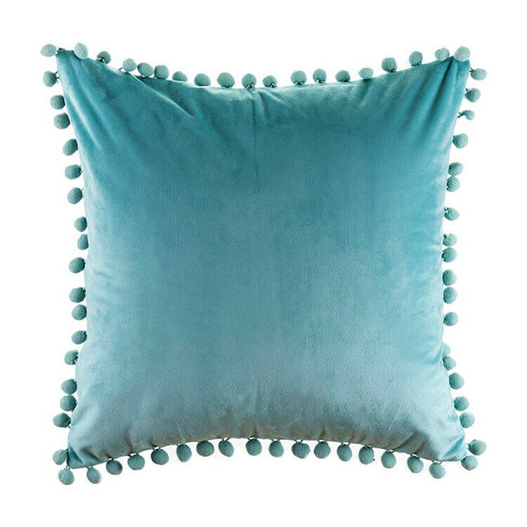 Tassel velvet cushion covers with pom poms in a stylish arrangement, showcasing their soft texture and vibrant color.