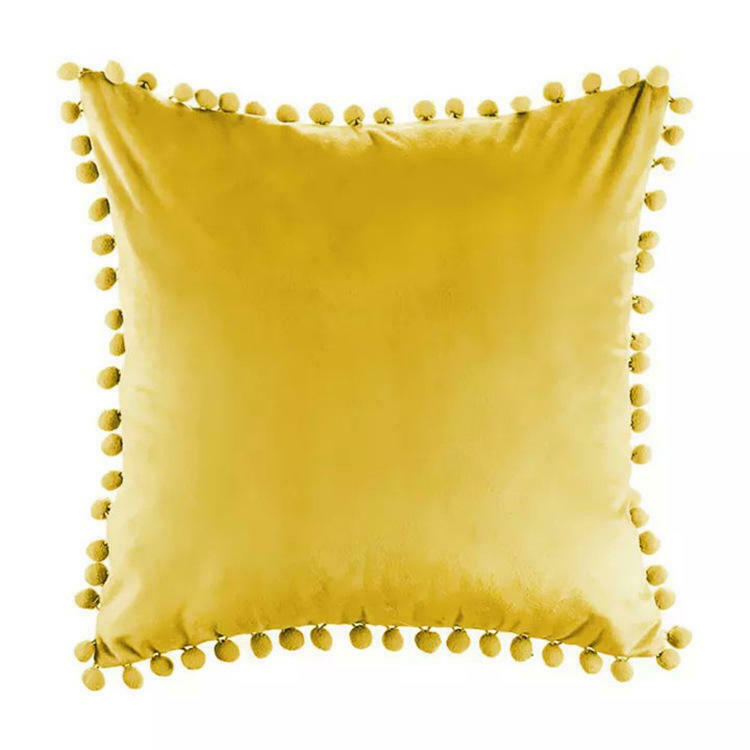 Tassel velvet cushion covers with pom poms in a stylish arrangement, showcasing their soft texture and vibrant color.