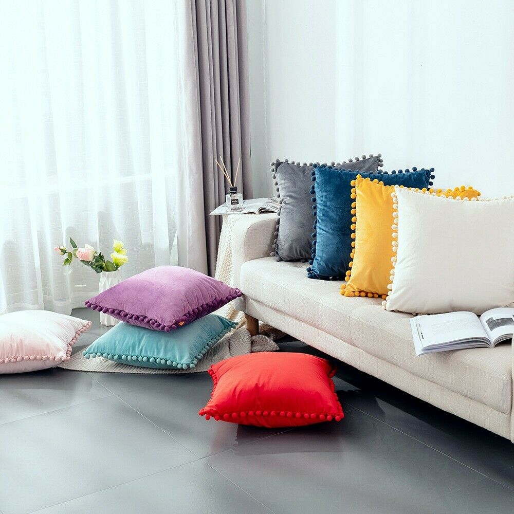 Tassel velvet cushion covers with pom poms in a stylish arrangement, showcasing their soft texture and vibrant color.