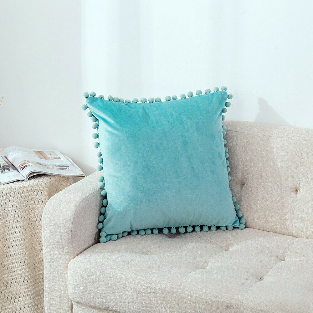 Tassel velvet cushion covers with pom poms in a stylish arrangement, showcasing their soft texture and vibrant color.