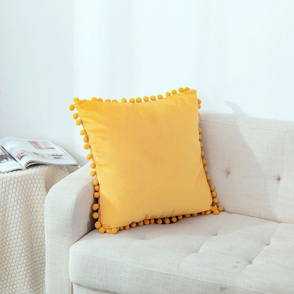 Tassel velvet cushion covers with pom poms in a stylish arrangement, showcasing their soft texture and vibrant color.