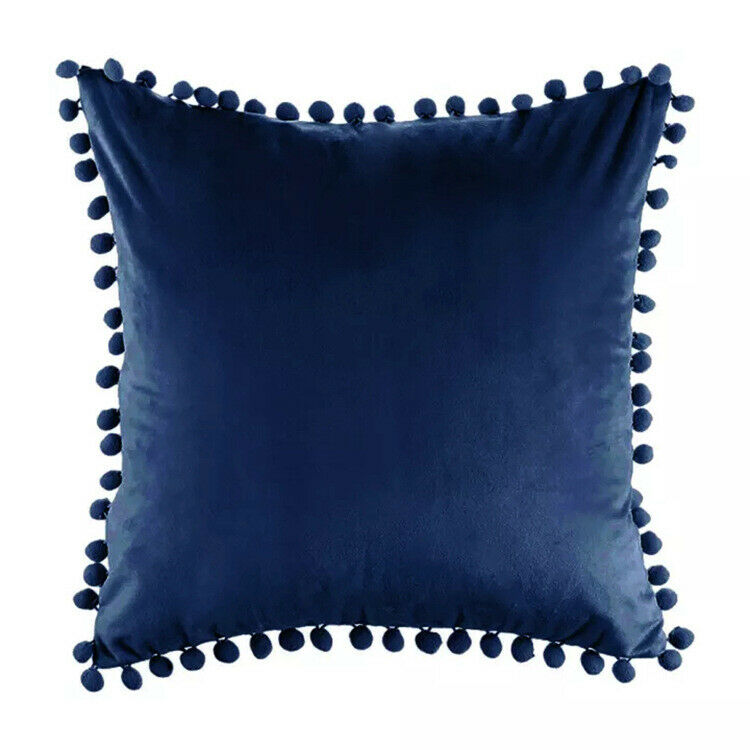 Tassel velvet cushion covers with pom poms in a stylish arrangement, showcasing their soft texture and vibrant color.