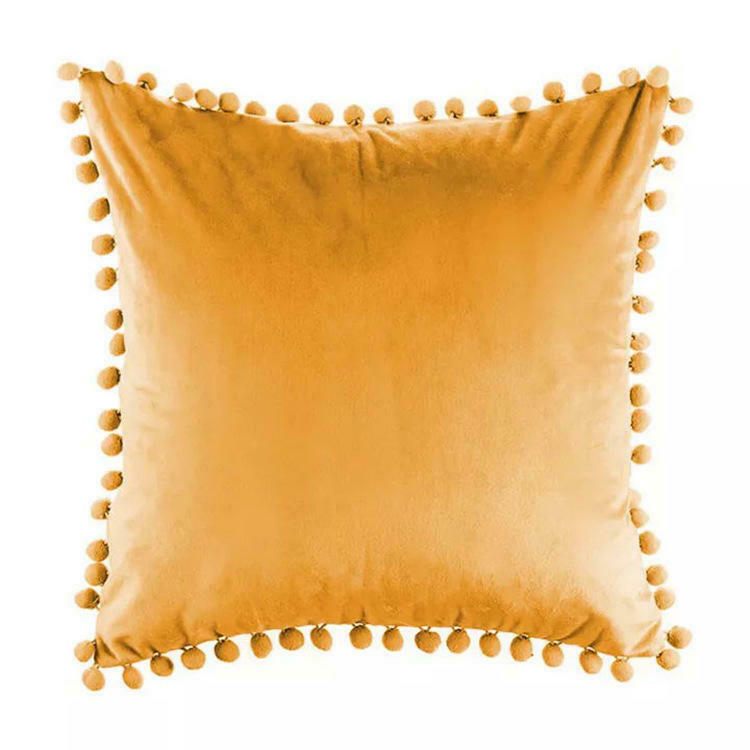 Tassel velvet cushion covers with pom poms in a stylish arrangement, showcasing their soft texture and vibrant color.