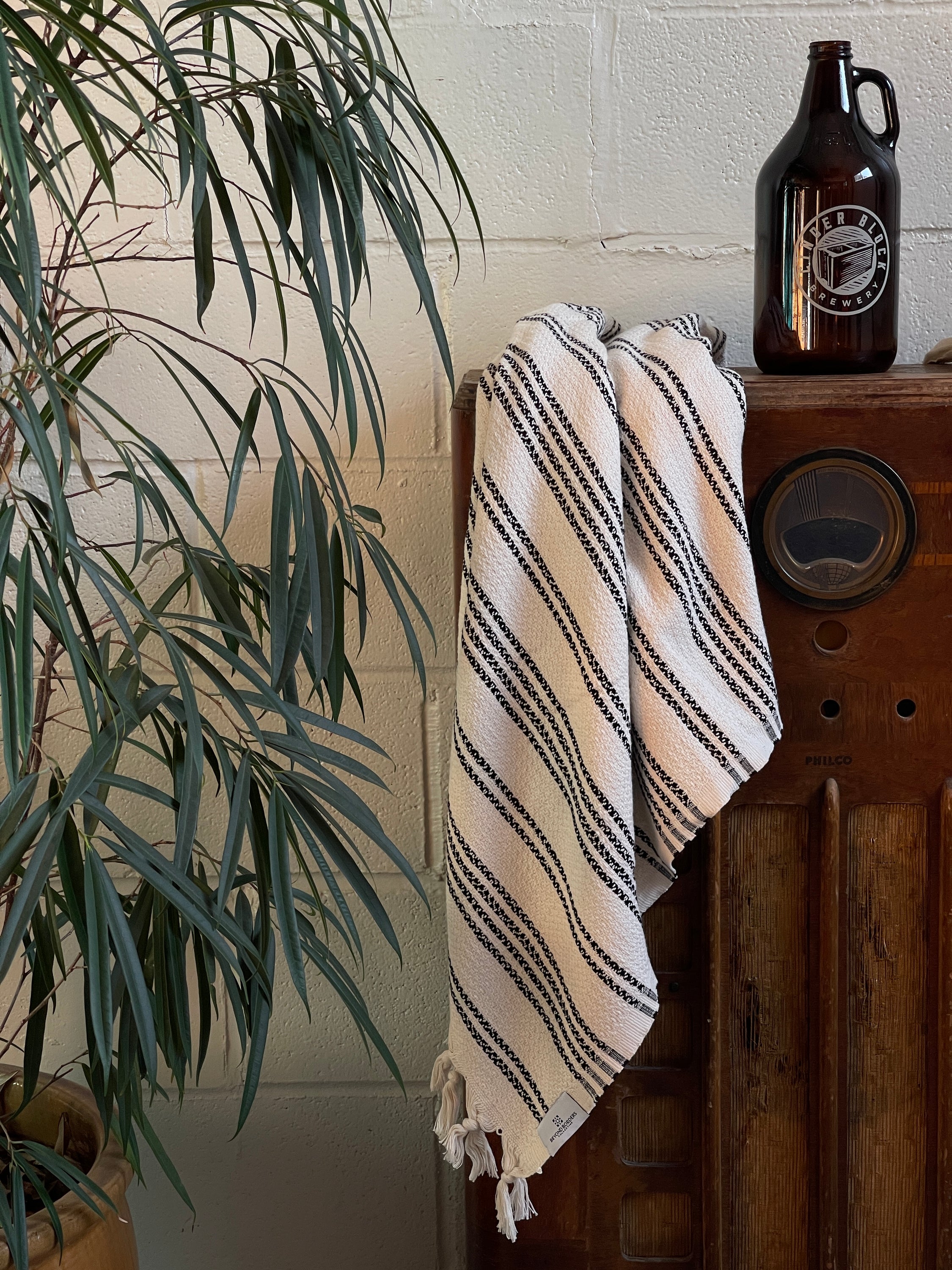 Vadi Turkish Cotton Towel in Cream and Black, showcasing its soft texture and versatile design, perfect for beach and home use.