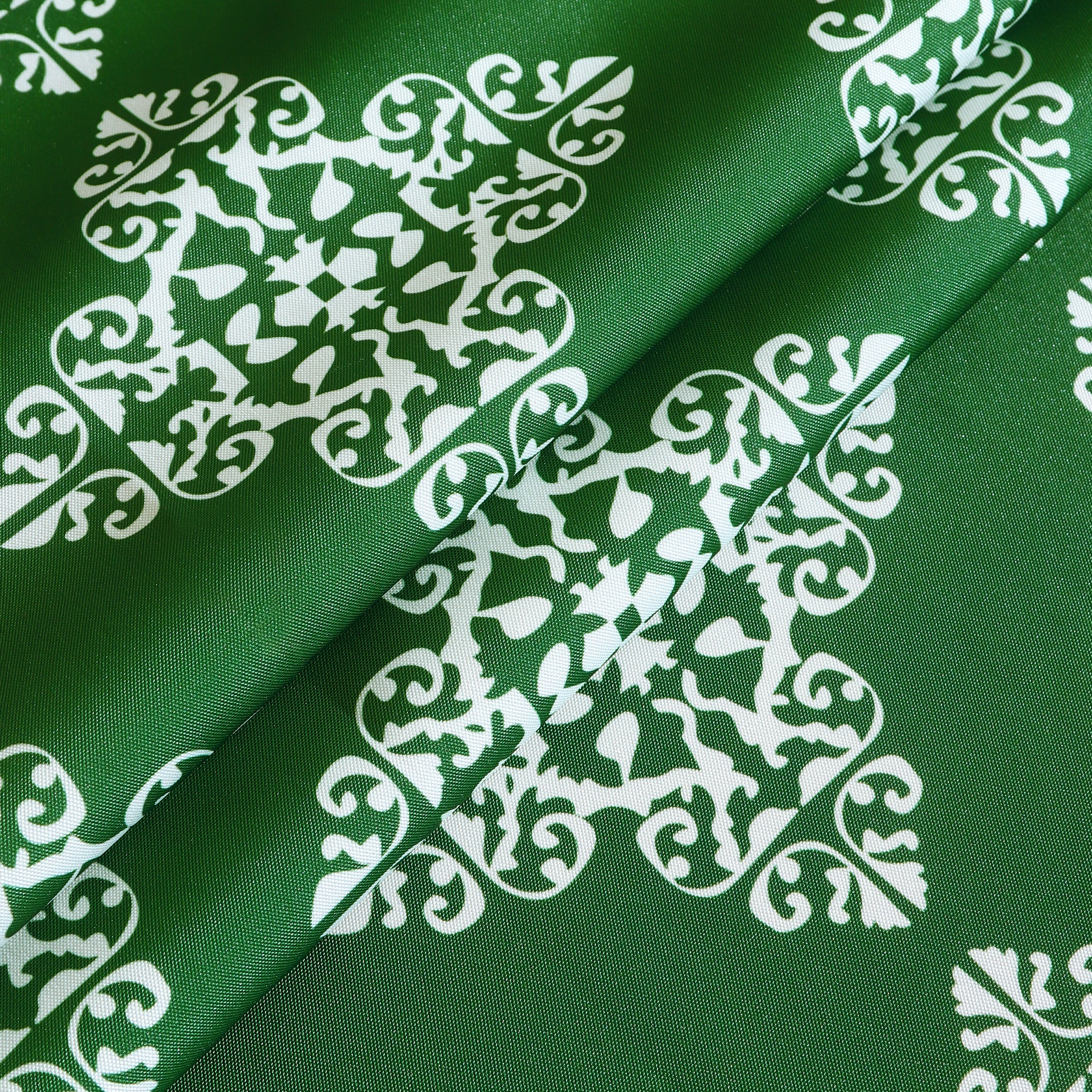 Water resistant green table cloth with geometric pattern, suitable for indoor and outdoor use.