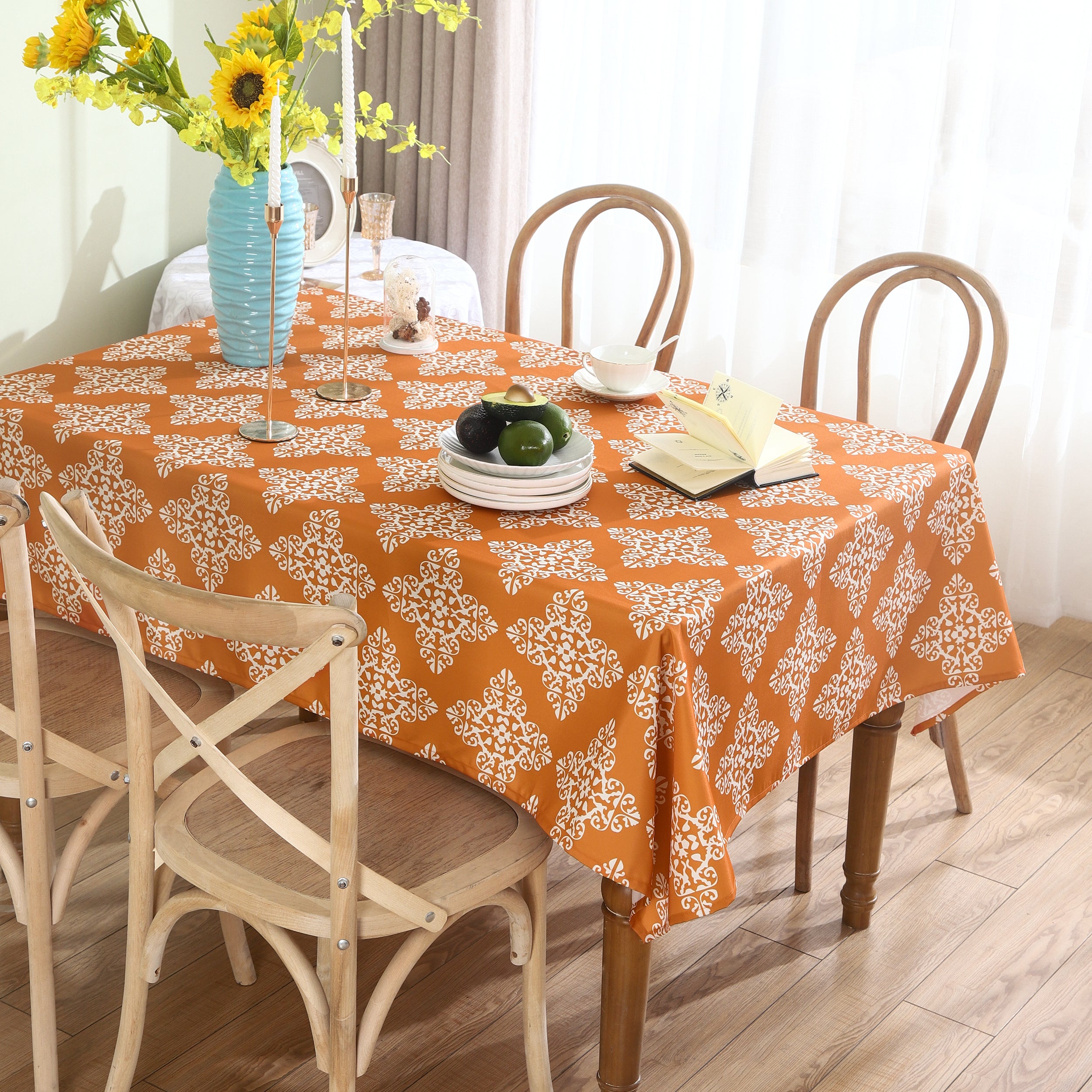 Orange water-resistant table cloth with geometric pattern, suitable for indoor and outdoor use.