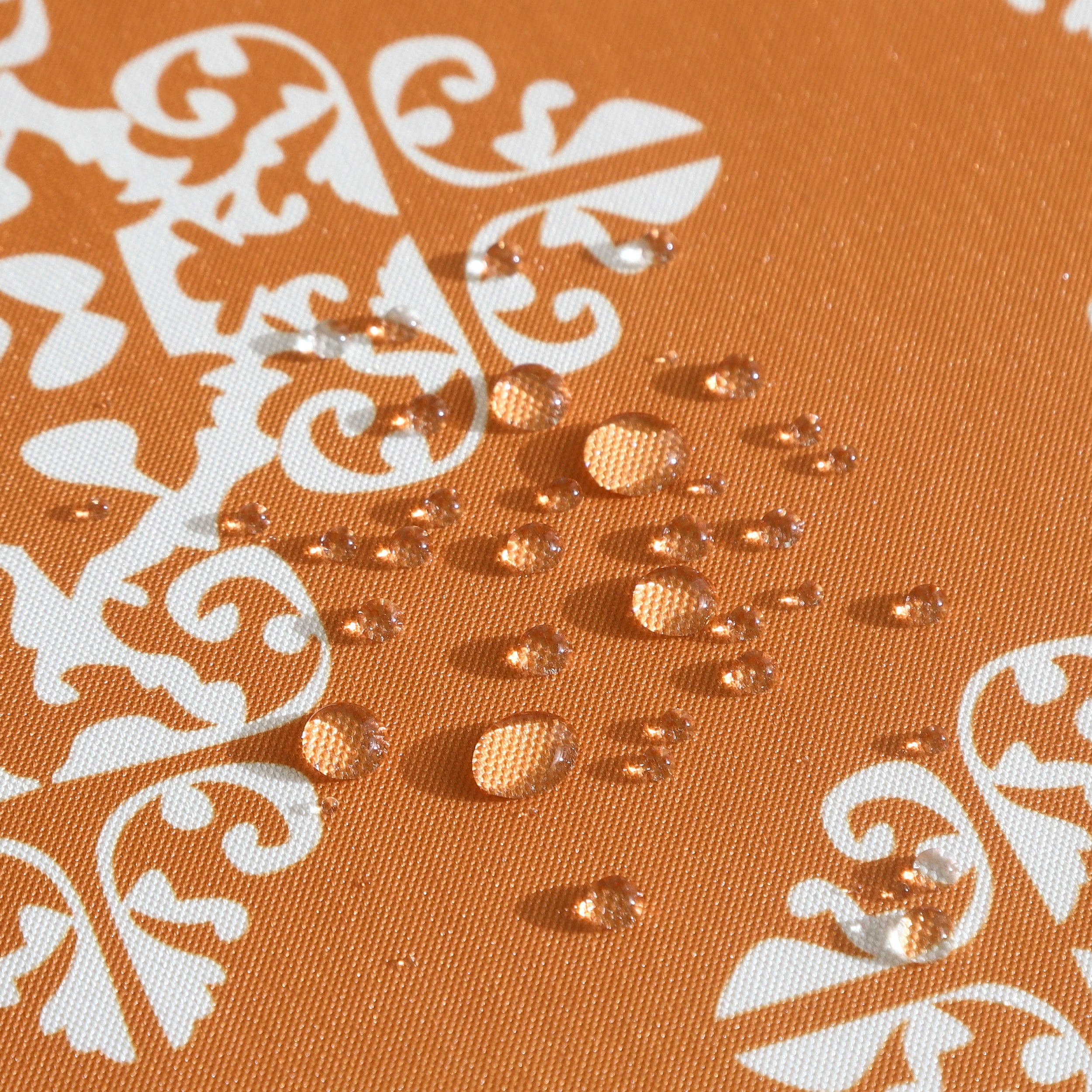 Orange water-resistant table cloth with geometric pattern, suitable for indoor and outdoor use.