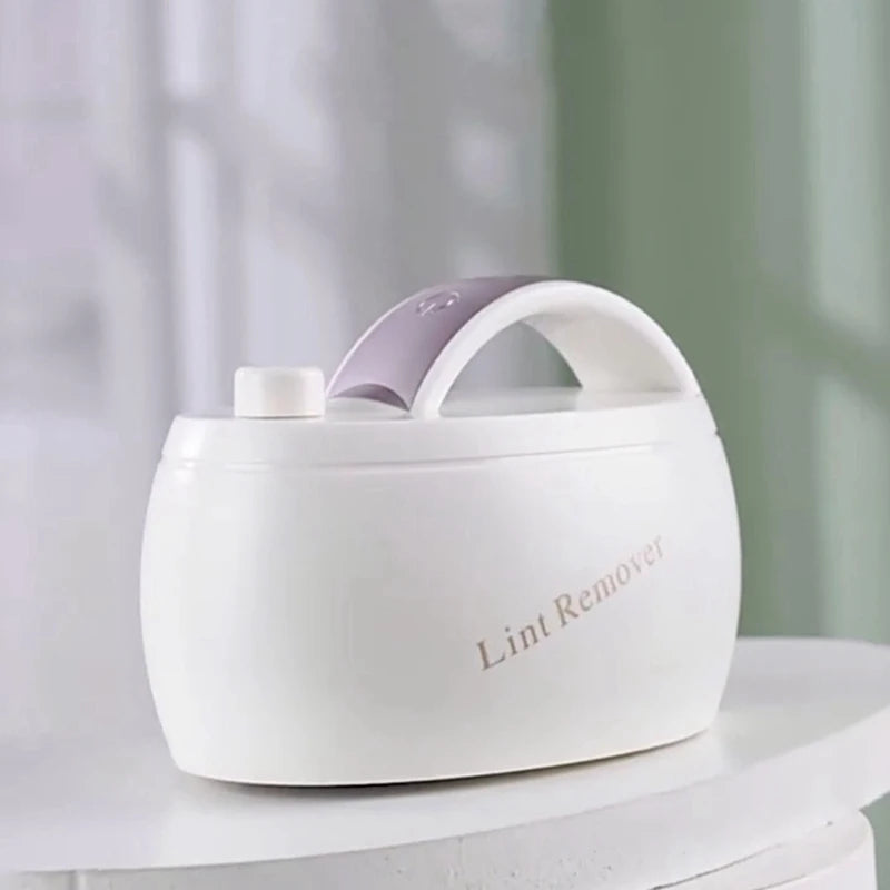 Rechargeable fabric shaver in white and gold, designed for removing lint and fuzz from various fabrics.