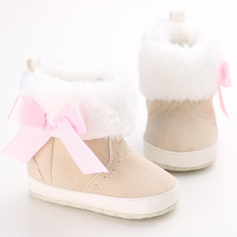 A pair of Super Warm Infant Soft Bottom Snow Boots for baby boys and girls, featuring a soft bottom and slip-on design, perfect for winter.