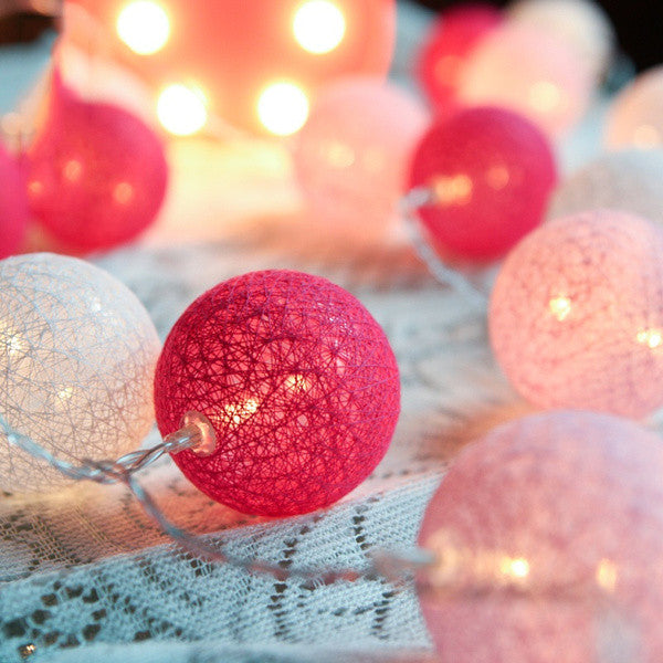 A set of 20 pink cotton ball string lights, battery powered, perfect for decoration.