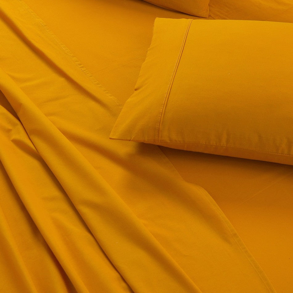 100% Egyptian Cotton Vintage Washed 500TC Mustard King Bed Sheets Set displayed on a bed, showcasing its luxurious texture and elegant design.