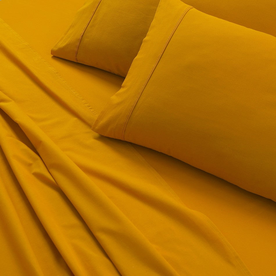 100% Egyptian Cotton Vintage Washed 500TC Mustard King Bed Sheets Set displayed on a bed, showcasing its luxurious texture and elegant design.