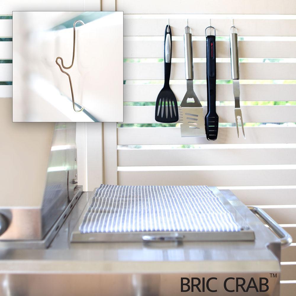 A pack of 10 Bric Crab Brick Hooks designed for hanging items on external bricks, showcasing their stainless steel construction and spring design.