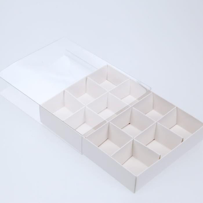 A set of 10 elegant white gift boxes with clear plastic lids, designed for chocolates and small gifts, showcasing their compartments and flat-packed design.