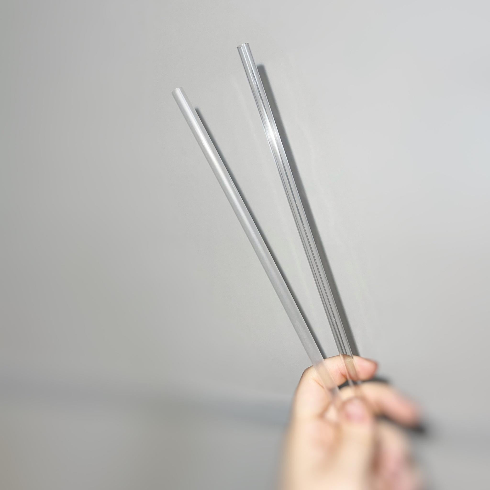 A set of 10.5” clear reusable straws displayed in a neat arrangement, showcasing their transparent design and eco-friendly packaging.